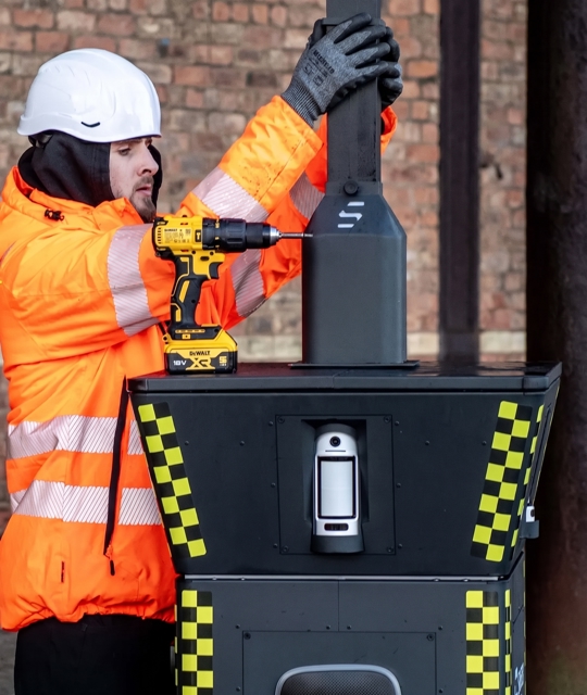 Engineer installing a CCTV power on a Safer Group pod
