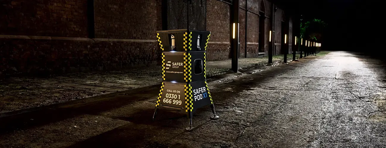 Safer POD X1 with strobing white deterrence lights on a dark street.