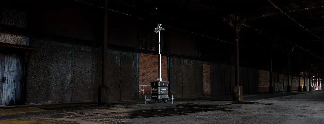 Safer POD S7 with a long CCTV mast outside a dark warehouse.