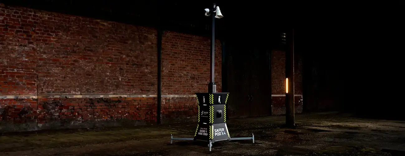 Safer Group X4 security tower with CCTV mast in a dark warehouse.